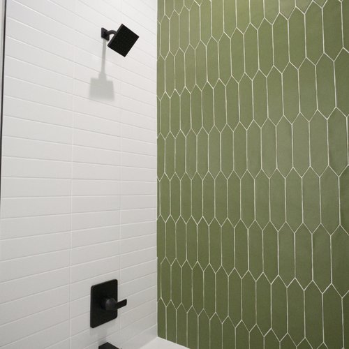 Trendy shower with a green tile accent wall in Arizona